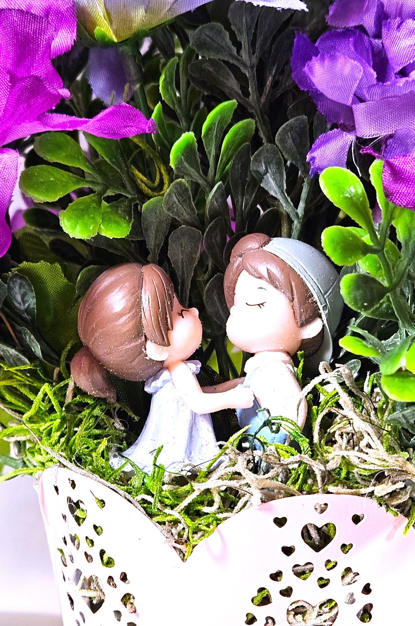 Heartwarming Flower Arrangement with a Kissing Couple Among Blue, Lilac, and Pink Florals Plus Sparkly Hearts