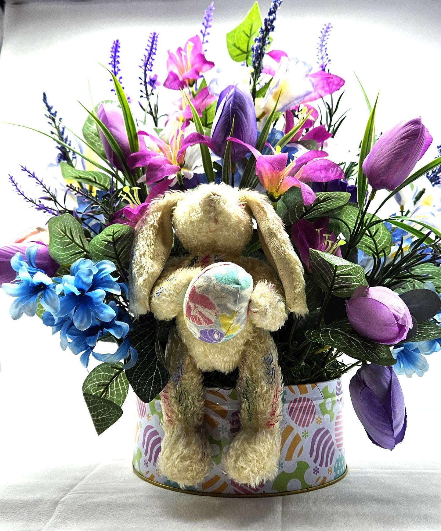 Large Easter Egg Tin with Vintage Rabbit Holding an Egg and Sitting amidst Purple/Lilac Lilies/Tulips and Blue Hyacinths