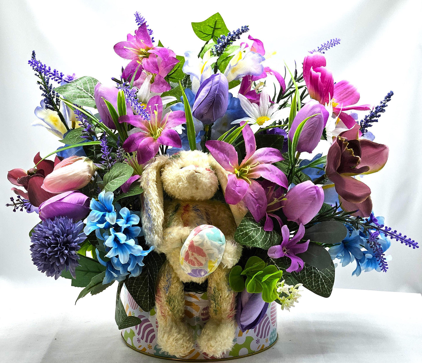 Large Easter Egg Tin with Vintage Rabbit Holding an Egg and Sitting amidst Purple/Lilac Lilies/Tulips and Blue Hyacinths