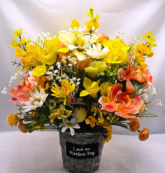 Mother's Day Bouquet in Wicker Type Pot/Love on Mother's Day/Featuring a Cheerful Bird in a Garden of Vibrant Yellow/Peach Flowers/Butterfly