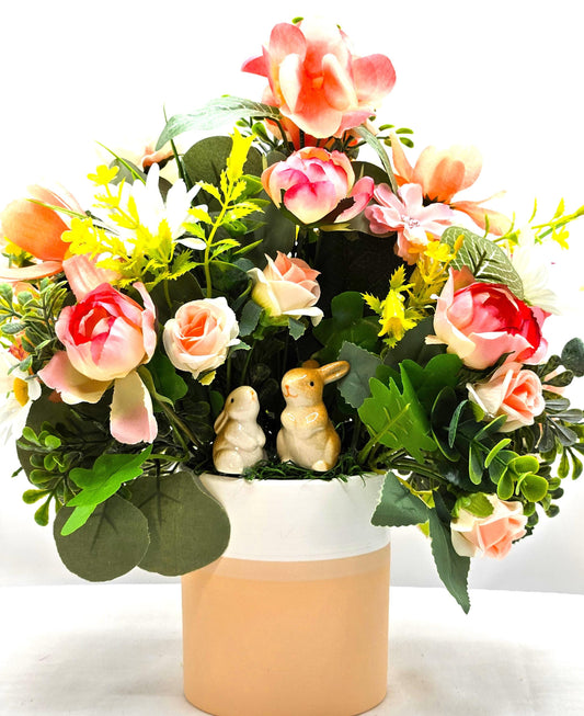 Ceramic Bunnies in a Pink/Peach/Yellow Flower Garden, Lush Greens and Baby's Breath, All Nestled in a Two Tone Ceramic Beige/White Vase