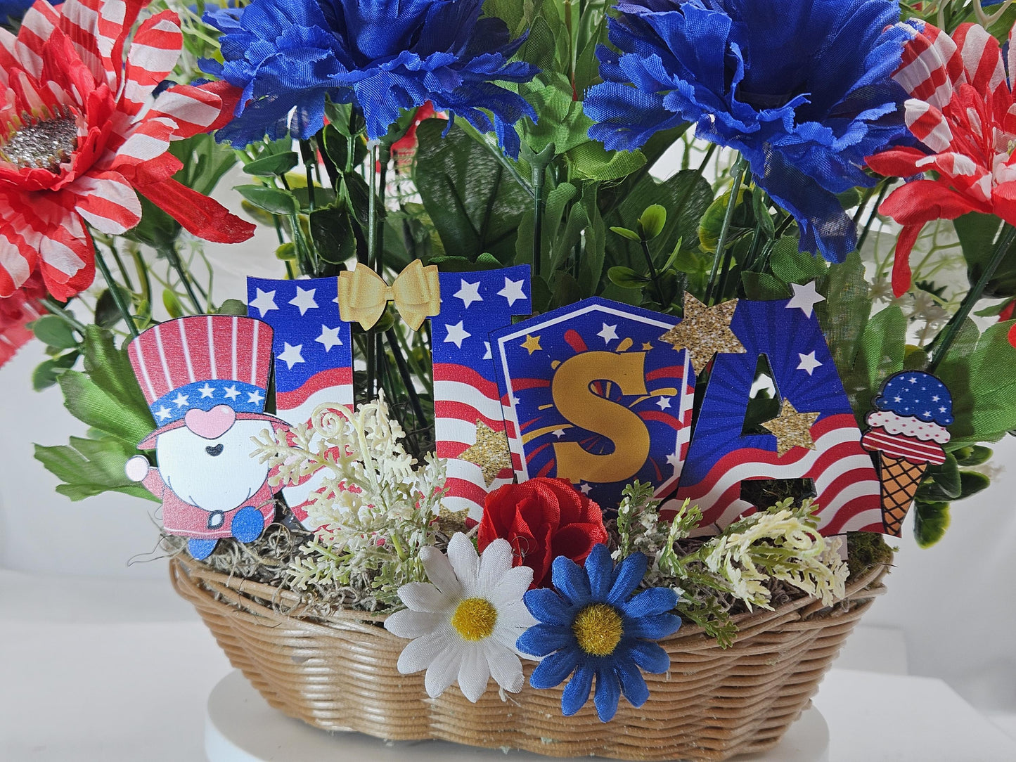 Gnome in the USA Patriotic Flower Arrangement, Oval Wicker Basket, Red White Blue Daisies, Sunflowers, Carnations