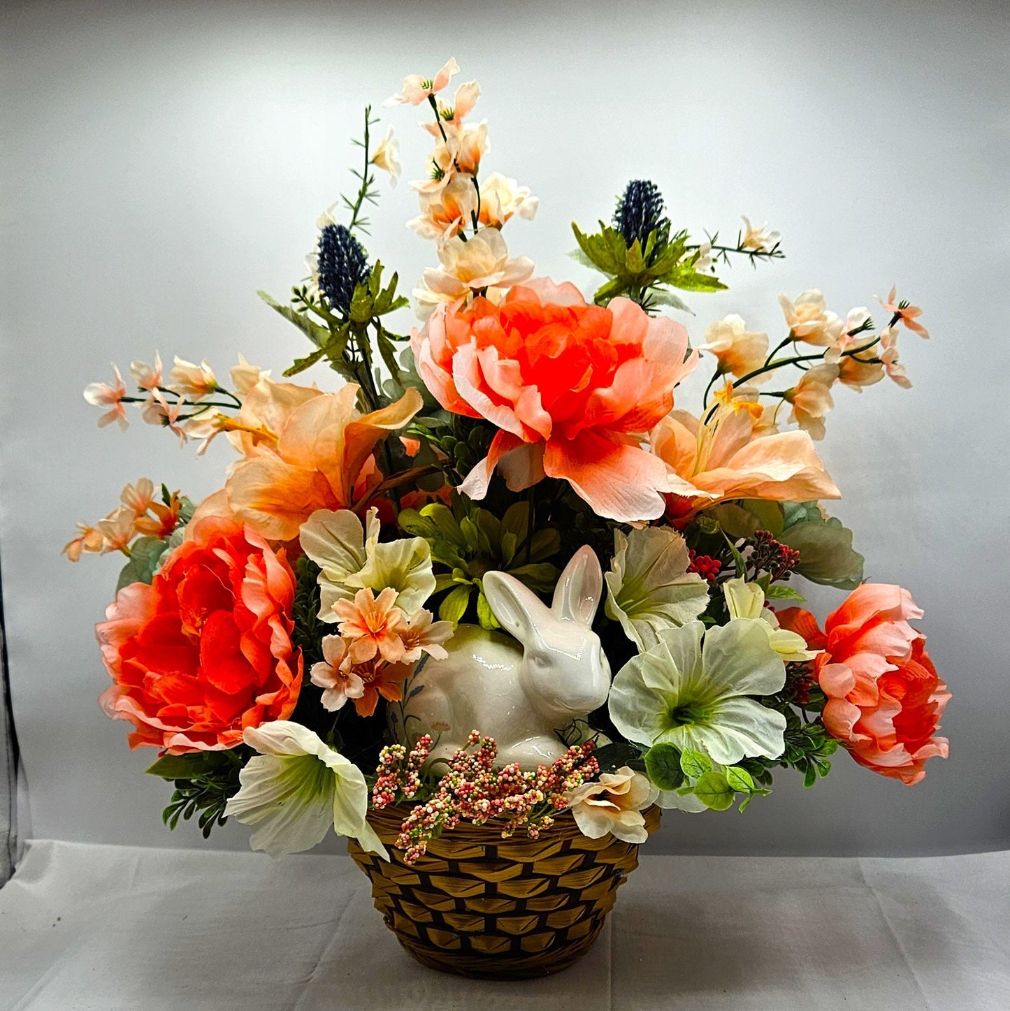 Elegant Spring Centerpiece with Bunny in Wicker Basket,  Peach and Jade Colored Peonies, Petunias and other Spring Flowers