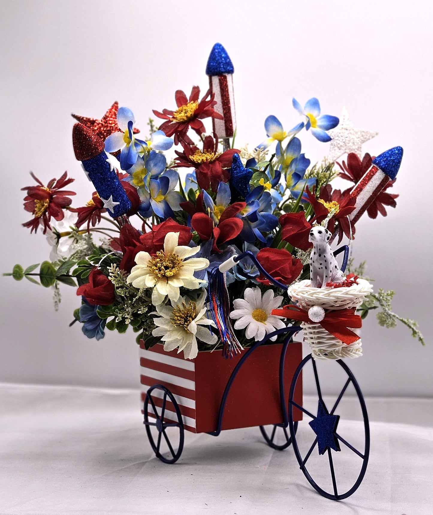 Americana Flower Arrangement Set in Bicycle Container with Red/White/Blue Flowers, sparkly Firecrackers and Stars, Basket with Dalmatian Dog