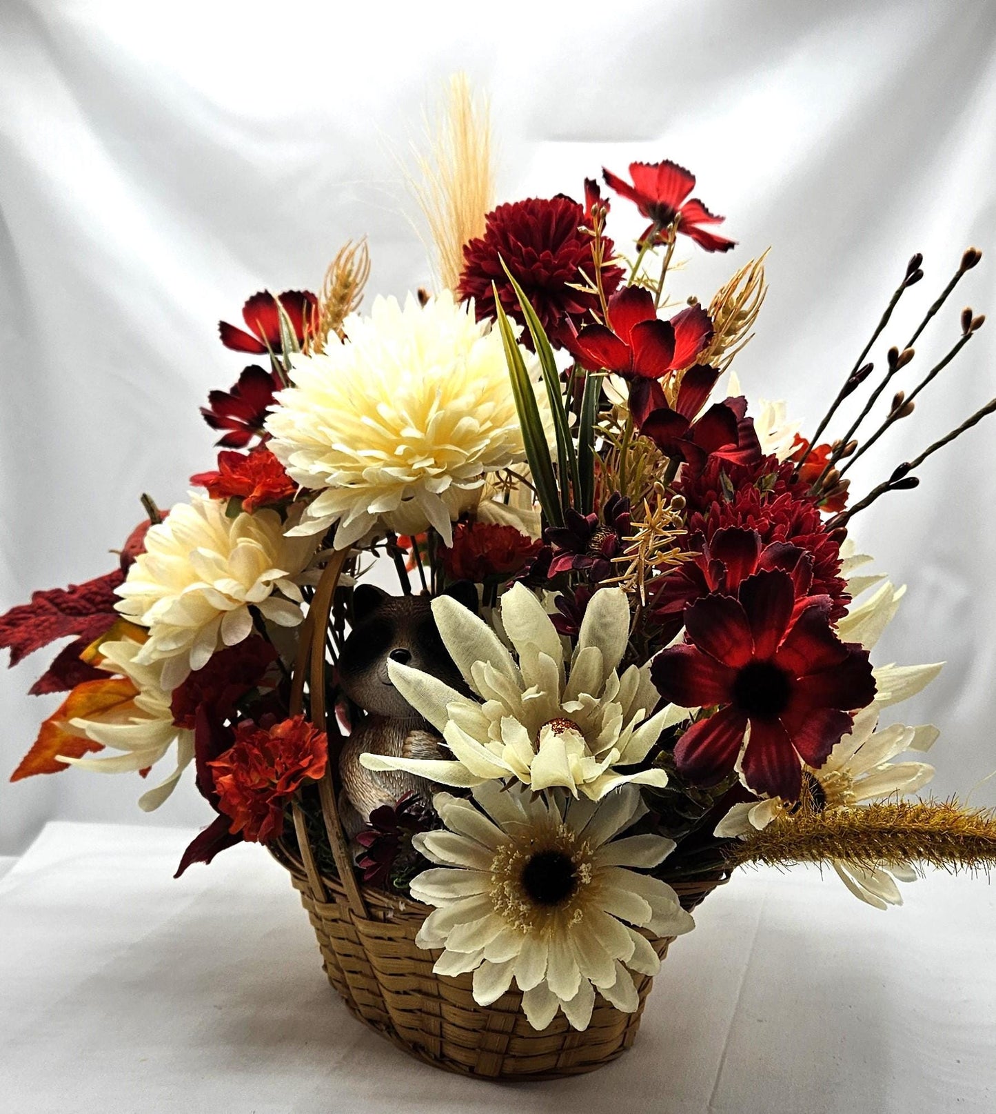 Deep Red and White Mums, Daisies, Other Wildflowers/Fall Leaves/Woodland Raccoon, Set in Handle Wicker Basket, Fall/Autumn Accents