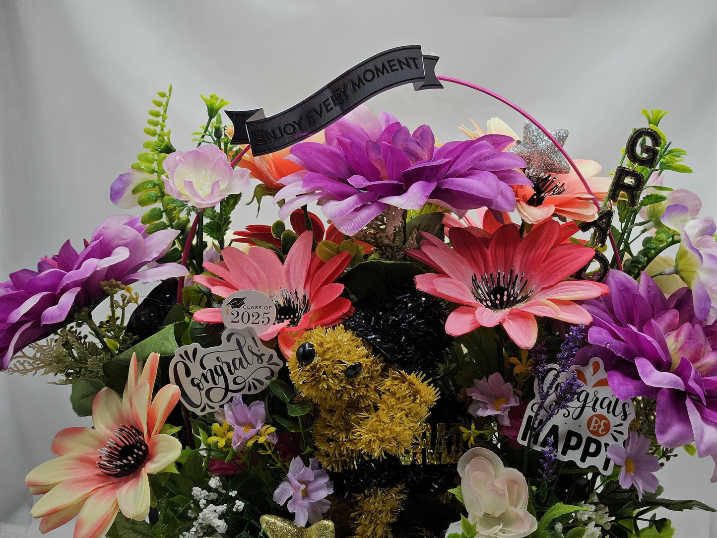 Whimsical Graduation Flower Arrangement in Pink Wicker Basket, Congrats and Enjoy Every Moment Signs with Pink/Purple Florals/Greenery